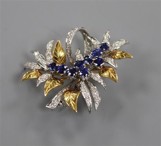 A modern 18ct white and yellow gold, sapphire and diamond set floral spray brooch, 39mm.